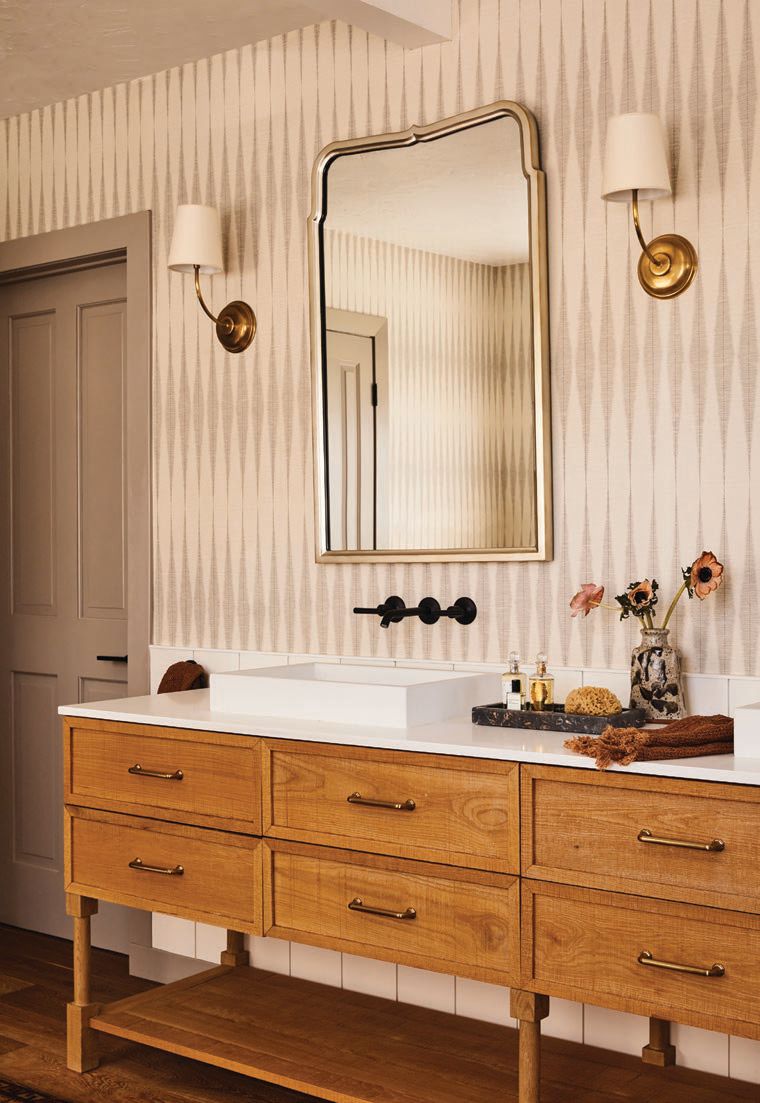 The primary bathroom’s mirror is by Michael Smith for Mirror Image Home. Photographed By Sam Frost