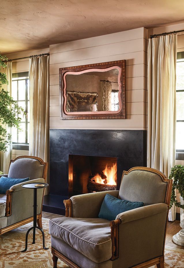 Antique French bergere chairs from Nickey Kehoe surround the fireplace in the salon Photographed By Sam Frost