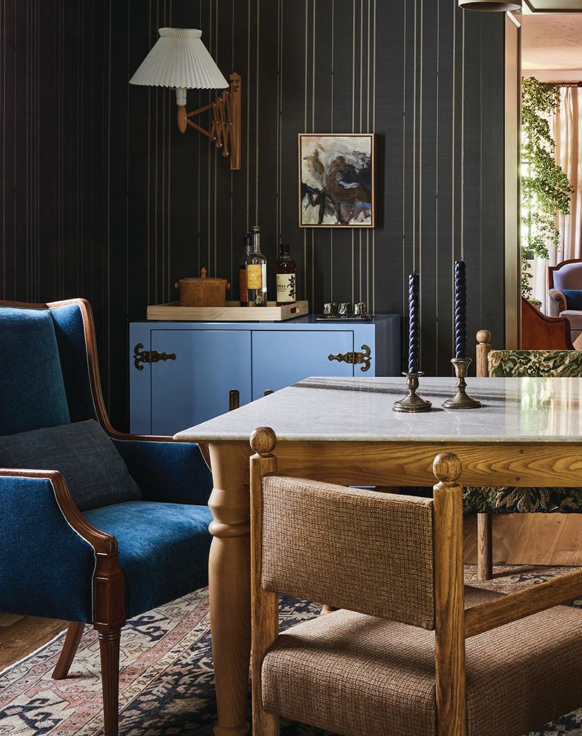The dramatic dining room contains Martin & Brockett’s Sydney chairs and the Arcadia cabinet by Lawson-Fenning, painted in a custom periwinkle shade Photographed By Sam Frost