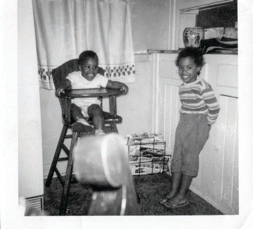 A young Kevin and Krystal in their childhood home’s kitchen. PHOTO COURTESY OF THE SHIRLEY HARRY COLLECTION