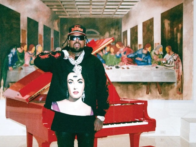 Westside Gunn in his home with painter Isaac Pelayo‘s 2022 rendition of Leonardo da Vinci’s “The Last Supper,” adorned with his signature smiley faces The rapper wearing his collaborative merch with painter Isaac Pelayo featuring “The Liz 2.” PHOTO BY @SNAPGOD